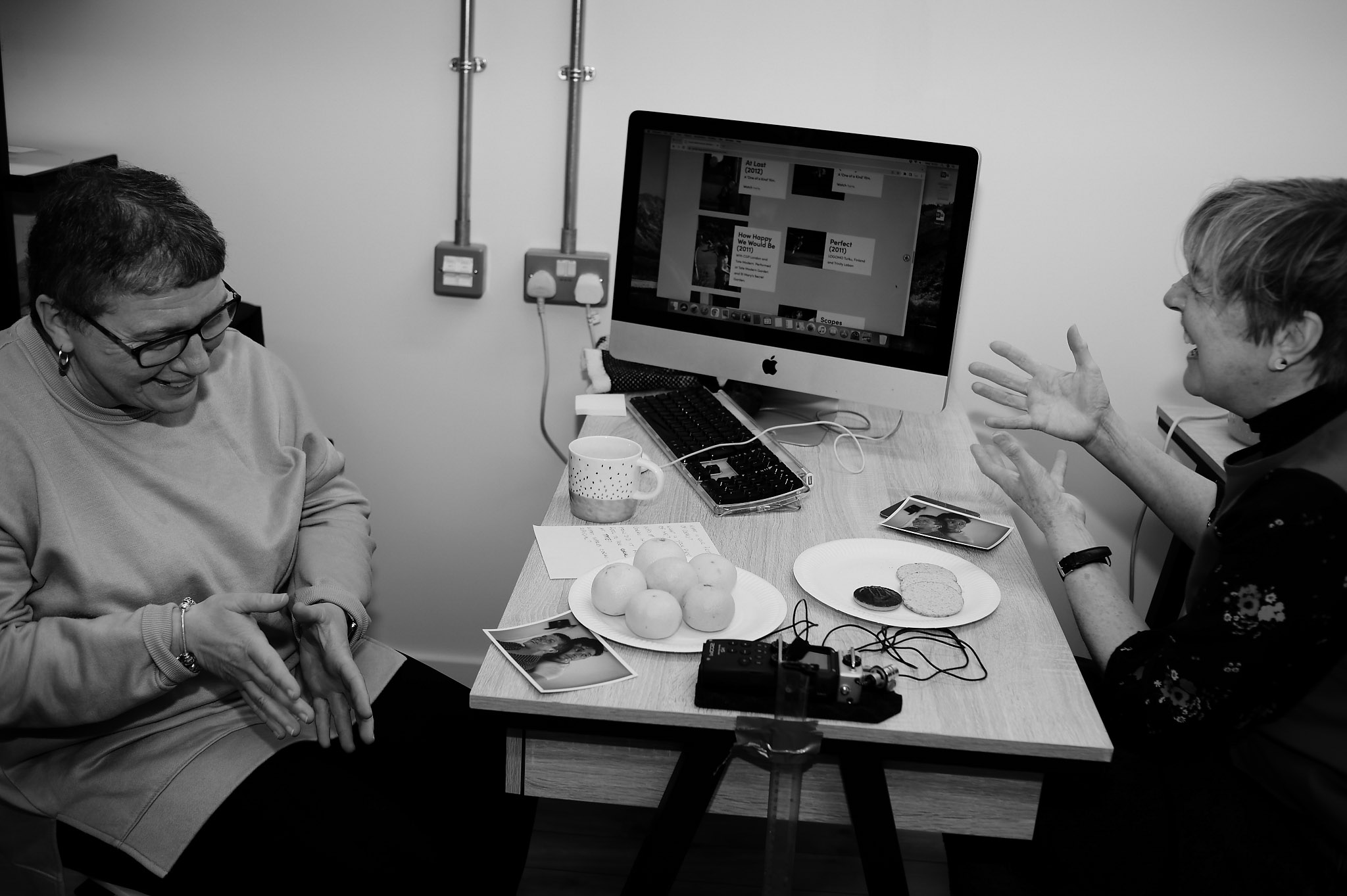 Black and white photo of Jackie interviewing Liz Ellis